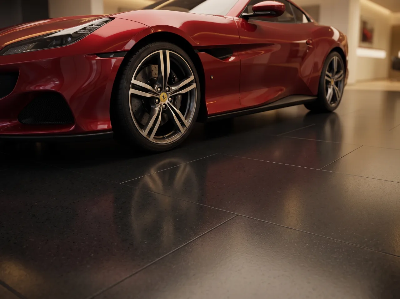 A red sports car wheel and lower body reflected on a sleek black Matnificent showroom garage floor